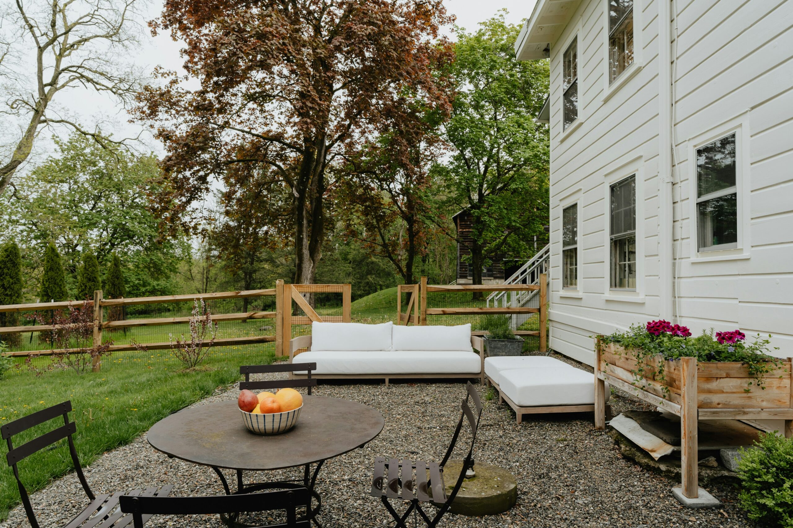 a patio with a table and chairs and a couch